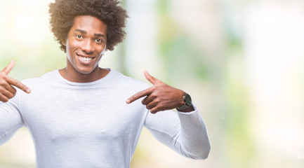 Afro american man over isolated background looking confident with smile on face, pointing oneself with fingers proud and happy.