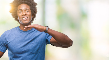 Afro american man over isolated background gesturing with hands showing big and large size sign, measure symbol. Smiling looking at the camera. Measuring concept.
