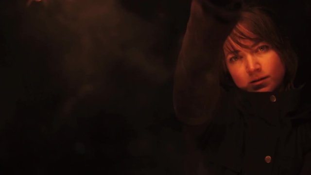 Slowmotion close up face shot of woman with fire fans