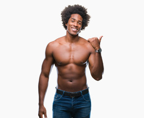 Fototapeta premium Afro american shirtless man showing nude body over isolated background smiling with happy face looking and pointing to the side with thumb up.