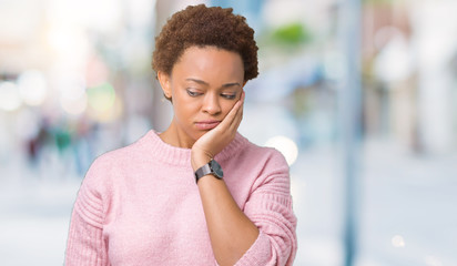Beautiful young african american woman over isolated background thinking looking tired and bored...