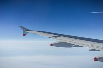 Flying above the clouds; another aircraft flying in the background