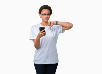 Young african american woman using smartphone over isolated background with angry face, negative sign showing dislike with thumbs down, rejection concept