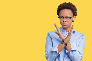 Young beautiful african american business woman over isolated background Rejection expression crossing arms doing negative sign, angry face