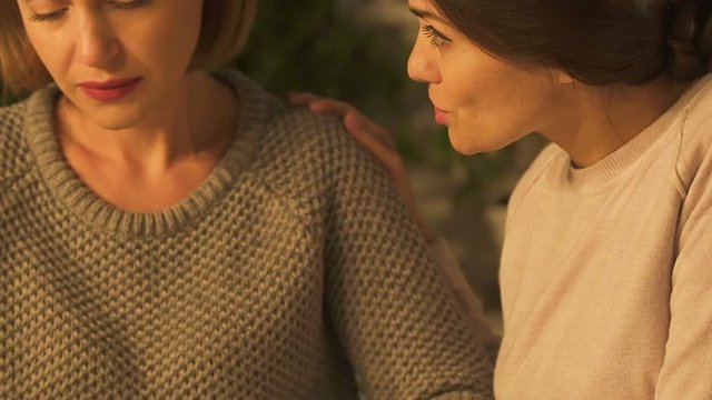 Friend supporting crying woman, giving advices and offering help, closeup