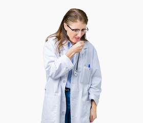 Middle age mature doctor woman wearing medical coat over isolated background feeling unwell and coughing as symptom for cold or bronchitis. Healthcare concept.