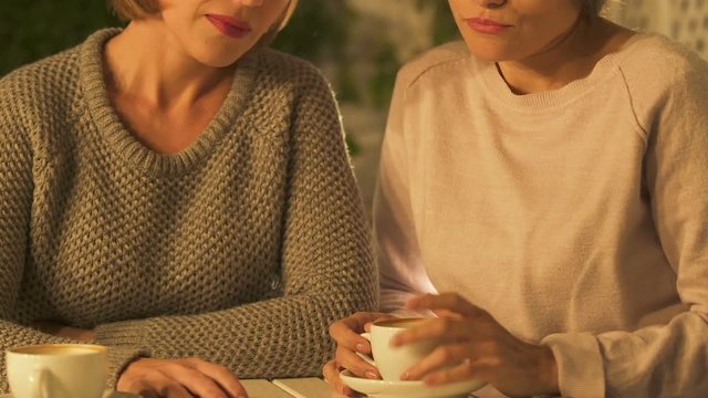 Envious women gossiping, jealous of friend success, unfaithful female friendship