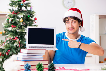 Young student with book at Christmas eve 