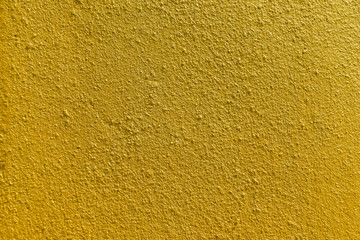 Golden concrete wall Texture. Gold color paint on cement wall background for backdrop design