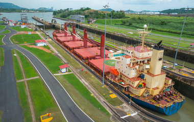 Large cargo ships pass through the Panama Canal locks.  This everyday event, provides income from both fees and tourism for the whole country. © valleyboi63