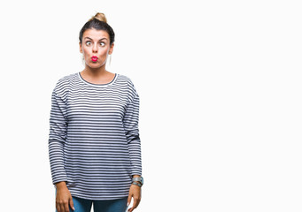 Fototapeta premium Young beautiful woman casual stripes sweater over isolated background making fish face with lips, crazy and comical gesture. Funny expression.