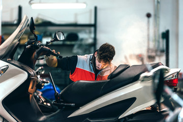 Mechanic working in the motorbike workshop