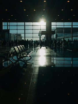 Silhouette of Travelers Queuing Up at Airport Gate