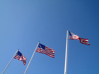 Obraz premium Three USA Flags wave in the air