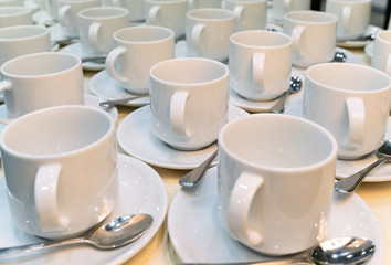 Group of empty coffee cups.
Many rows of white cup for service tea or coffee in breakfast at buffet event. 
Many rows of pure white cup.
