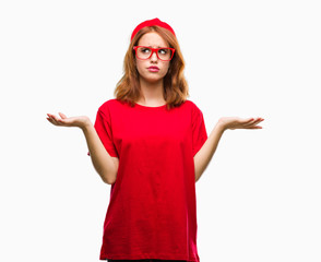 Young beautiful woman over isolated background clueless and confused expression with arms and hands...