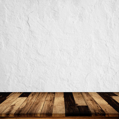 Empty wooden table with white concrete wall background.