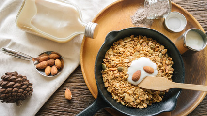 Fresh and Healthy breakfast with the grain and yogurt on the black pan close up shoot. minimal japanese style