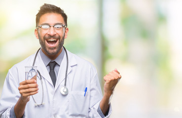 Adult hispanic doctor man drinking glass of water over isolated background screaming proud and celebrating victory and success very excited, cheering emotion