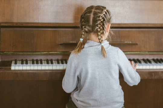 Little Girl Playing The Piano 
