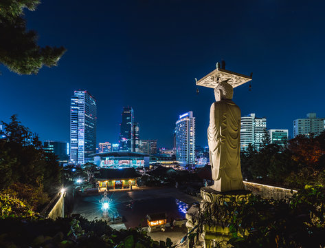 Big buddha statue at bongeunsa temple with cityscape of seoul at night, south korea