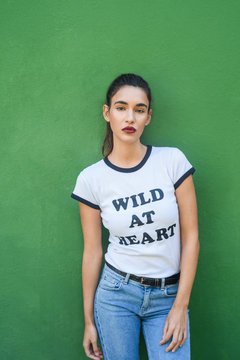 Casual confident woman standing on green