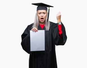 Young blonde woman wearing graduate uniform holding degree over isolated background annoyed and frustrated shouting with anger, crazy and yelling with raised hand, anger concept