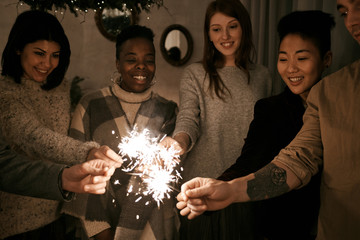 Friends with sparklers on party