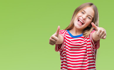 Young beautiful girl over isolated background approving doing positive gesture with hand, thumbs up...