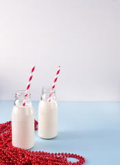 Christmas two bottles with milk with red beads