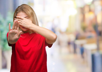 Young caucasian woman over isolated background covering eyes with hands and doing stop gesture with sad and fear expression. Embarrassed and negative concept.