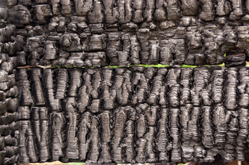 Black burnt wall of house of wooden planks with embossed texture. background for copy space. concept of loss of real estate or home. property insurance