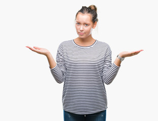 Young beautiful caucasian woman over isolated background clueless and confused expression with arms...