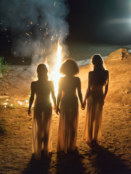 Sensual women in dress against fire