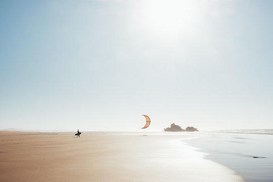 Kitesurfer walking on the beach
