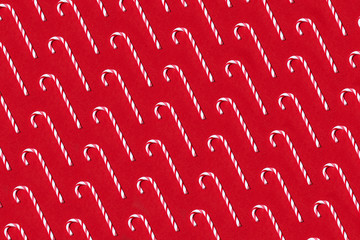 Candy canes pattern on red background