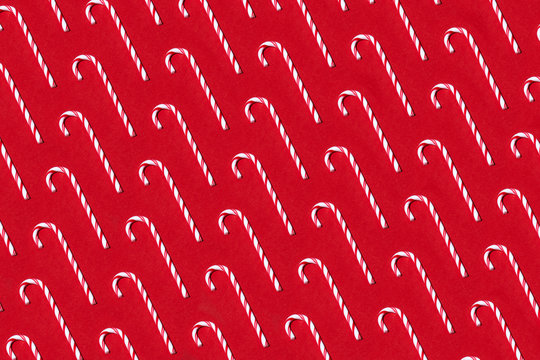 Candy canes pattern on red background