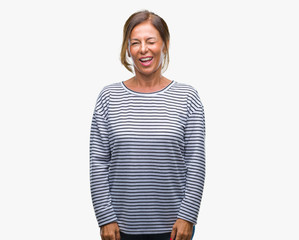 Middle age senior hispanic woman over isolated background winking looking at the camera with sexy...