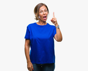 Middle age senior hispanic woman over isolated background pointing finger up with successful idea. Exited and happy. Number one.
