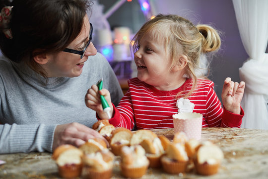 Woman and child making cupcakes together