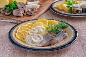 Sliced fish with potatos on plate