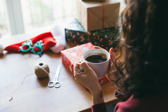 Woman wrapping Christmas presents indoor