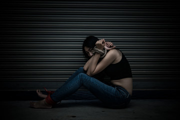 Asian hostage woman Bound with rope at night scene,The thieves kidnapped for ransom,thailand people