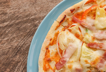 Hot pizza slice on wooden table