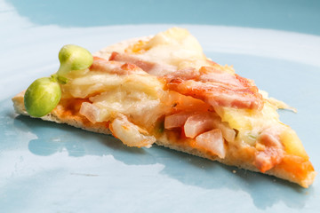 Hot pizza slice on wooden table