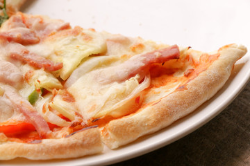 Hot pizza slice on wooden table