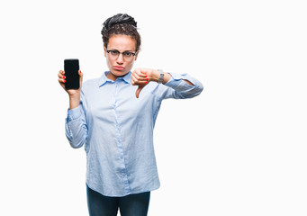 Young braided hair african american business girl showing screen of smartphone over isolated background with angry face, negative sign showing dislike with thumbs down, rejection concept