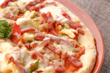 Hot pizza slice on wooden table