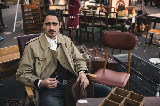 Man with Old Fashioned Raincoat at the Flea Market