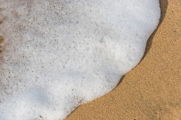 Surf Foam on a Sunny Beach